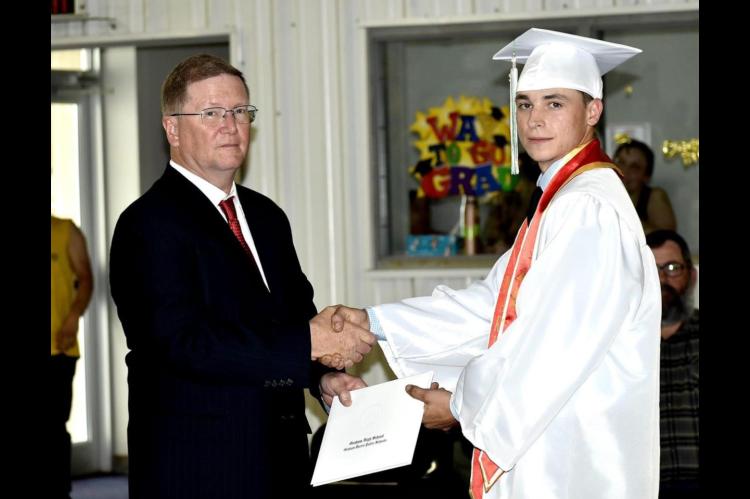 Graham-Dustin seniors receive diploma from Robert Holt, School Board President