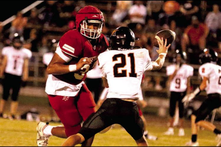 Phillip Ross closes in on the Longhorn quarterback. Photos by Dane Smart, Tribune Sports Reporter