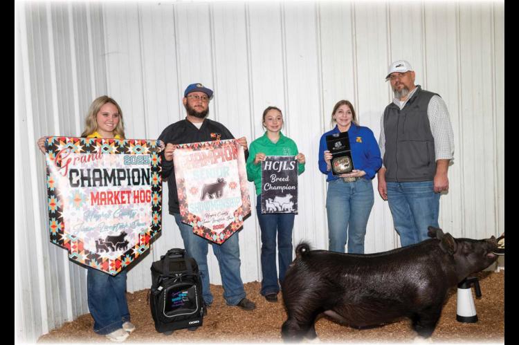 Moss FFA Member Avery Tyler (pictured in blue FFA shirt) earned Grand Champion Market Hog and Champion Senior Swine Showman