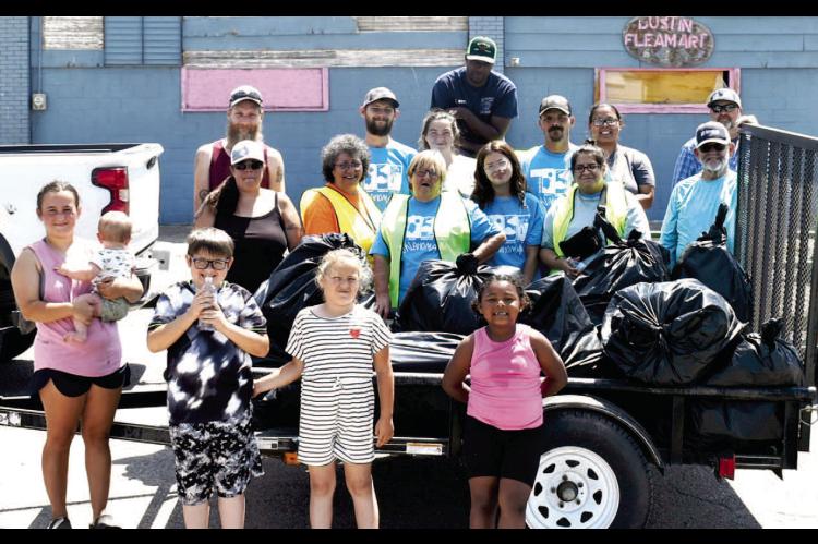 THE DUSTIN ACTIVITIES COMMITTEE SPONSORED A TRASH PICKUP FOR DUSTIN ON SATURDAY, MAY 17, 2025. TWENTY VOLUNTEERS PARTICIPATED AND THEY PICKED UP 16 BAGS OF TRASH. Pictured above are: Front row: Ayden McLaud and baby Bryder, Elijah McGirt, Gracie White and