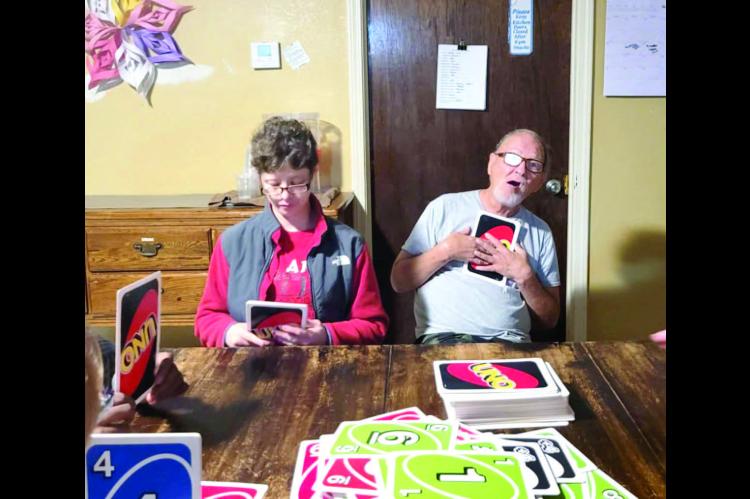 Amy and Danny strategizing over UNO!