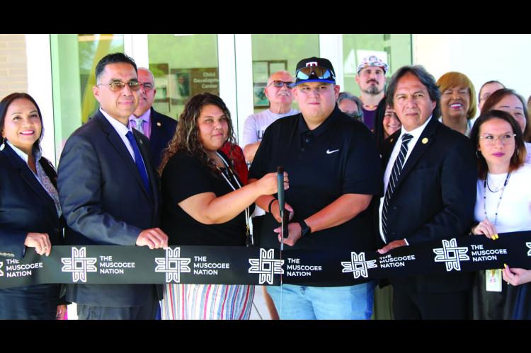 Muscogee Nation Principal Chief David Hill, tribal officials, child care staff and community members partici - pate in the ribbon-cutting ceremony June 1 for the new Mvskoke Child Development Center in Wetumka.