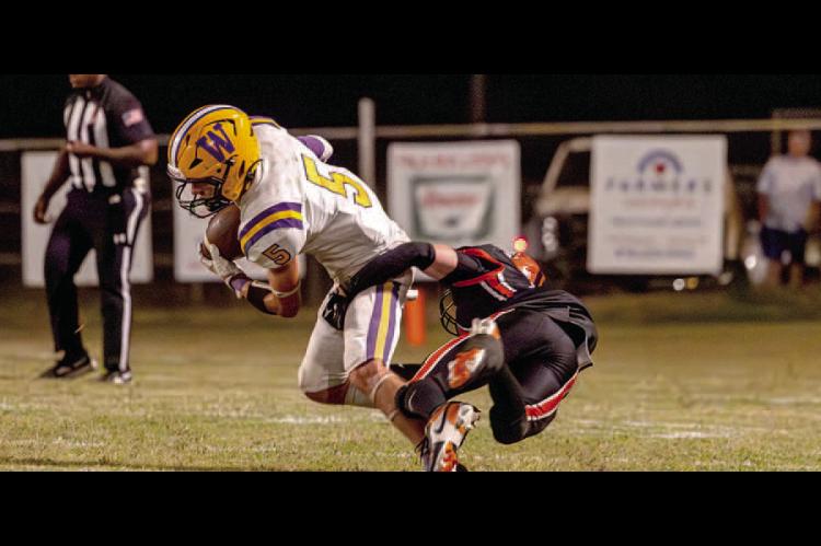 Weleetka Junior running back, Colt Richards breaks a tackle for a gain on the play