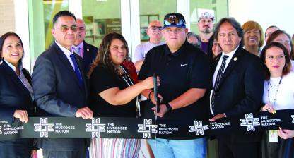 Muscogee Nation Principal Chief David Hill, tribal officials, child care staff and community members partici - pate in the ribbon-cutting ceremony June 1 for the new Mvskoke Child Development Center in Wetumka.