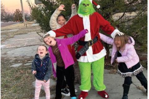 Remington Wright and Nina Poole say hi to Mr. and Mrs. Claus Nelly Robison and Liz Robison Trinity Ingle Marley Ingle tell Mr. Grinch he can’t steal their Christmas!