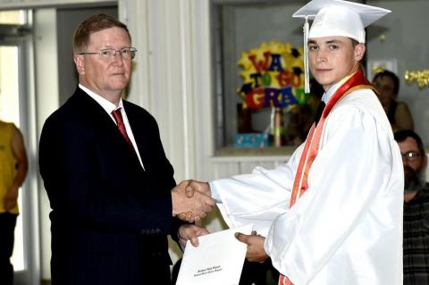 Graham-Dustin seniors receive diploma from Robert Holt, School Board President
