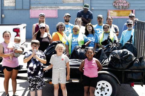 THE DUSTIN ACTIVITIES COMMITTEE SPONSORED A TRASH PICKUP FOR DUSTIN ON SATURDAY, MAY 17, 2025. TWENTY VOLUNTEERS PARTICIPATED AND THEY PICKED UP 16 BAGS OF TRASH. Pictured above are: Front row: Ayden McLaud and baby Bryder, Elijah McGirt, Gracie White and