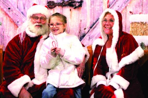 Hattie Harden was so happy to see Santa in Calvin this year. She loved her candy cane and can’t wait to see what Santa brings this year. Picture by Felisha Ring