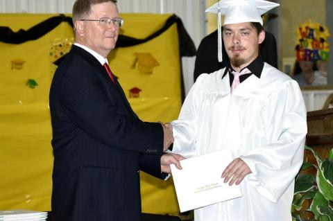 Graham-Dustin seniors receive diploma from Robert Holt, School Board President