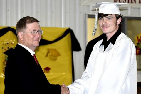 Graham-Dustin seniors receive diploma from Robert Holt, School Board President