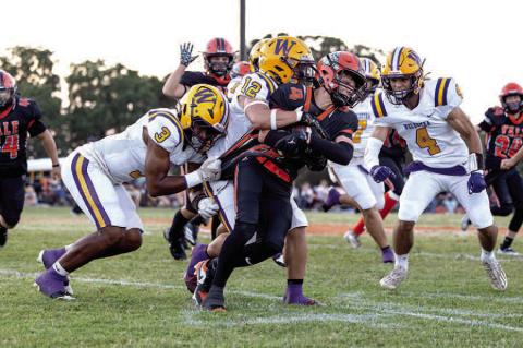 #12 Paul Lowry leads a gang of Outlaws in a big stop against the Yale offense.