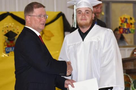 Graham-Dustin seniors receive diploma from Robert Holt, School Board President