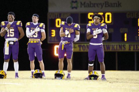The Outlaws pause to honor our great Nation before kickoff.