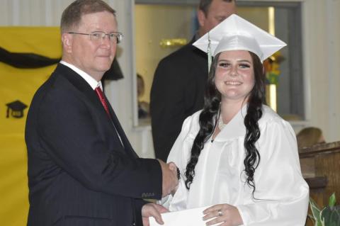Graham-Dustin seniors receive diploma from Robert Holt, School Board President