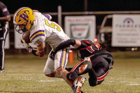 Weleetka Junior running back, Colt Richards breaks a tackle for a gain on the play