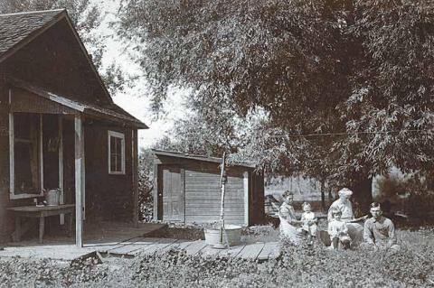 She’s sitting on her mother’s lap in this photo: