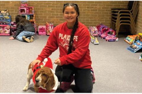 Jewel Hobia shows off her puppy in his Christmas sweater.